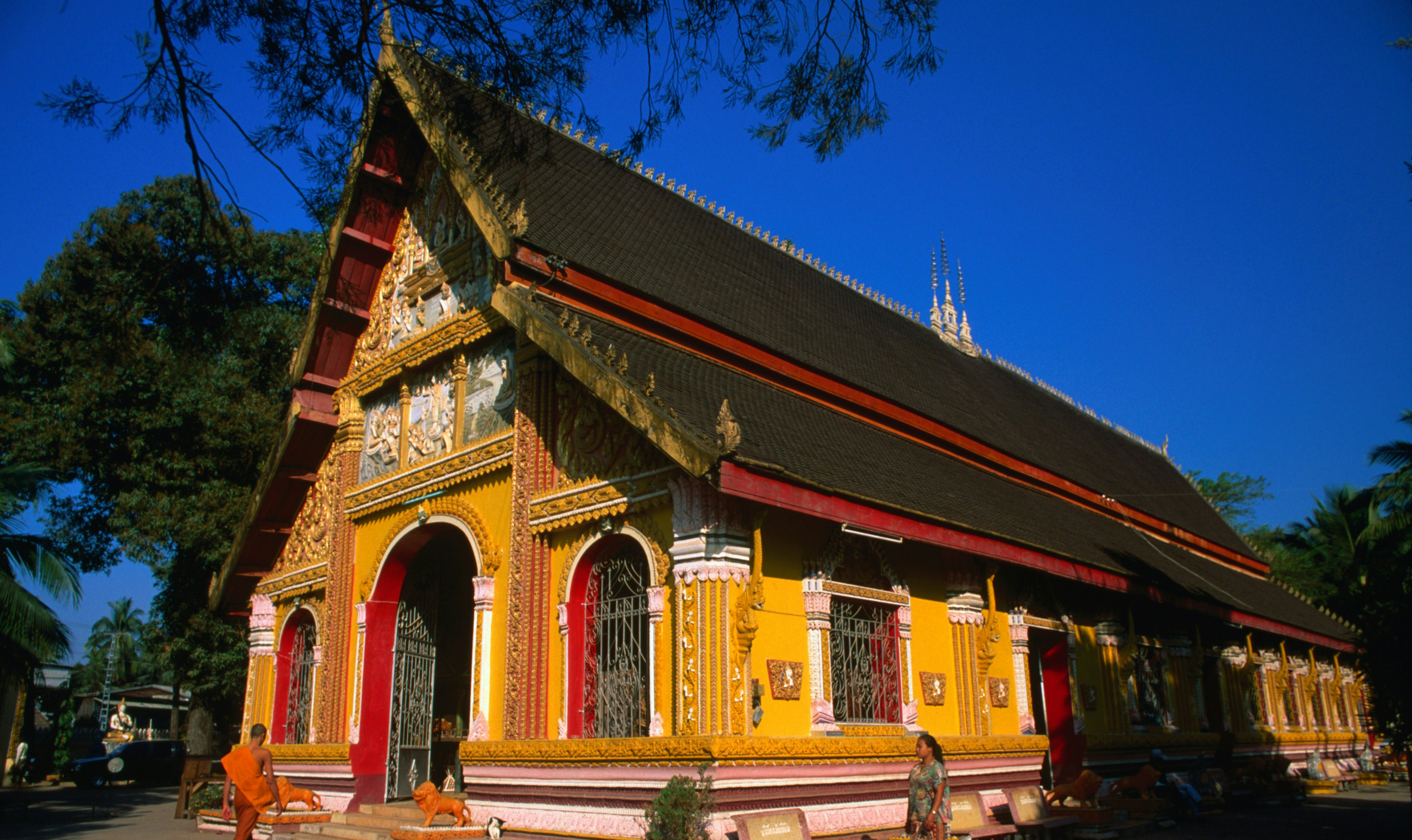 A monk enters the Wat Si Muang in Vientiane. The spot for this monastery was chosen in 1563