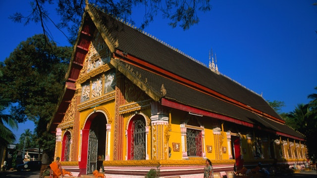 A monk enters the Wat Si Muang in Vientiane. The spot for this monastery was chosen in 1563
