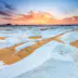 "Sunset over The White Desert, part of The Western Sahara Desert in Egypt. The White Desert of Egypt is located 45 km (28 mi) north of the town of Farafra. The desert has a white, cream color and has massive chalk rock formations that have been created as a result of occasional sandstorm in the area."