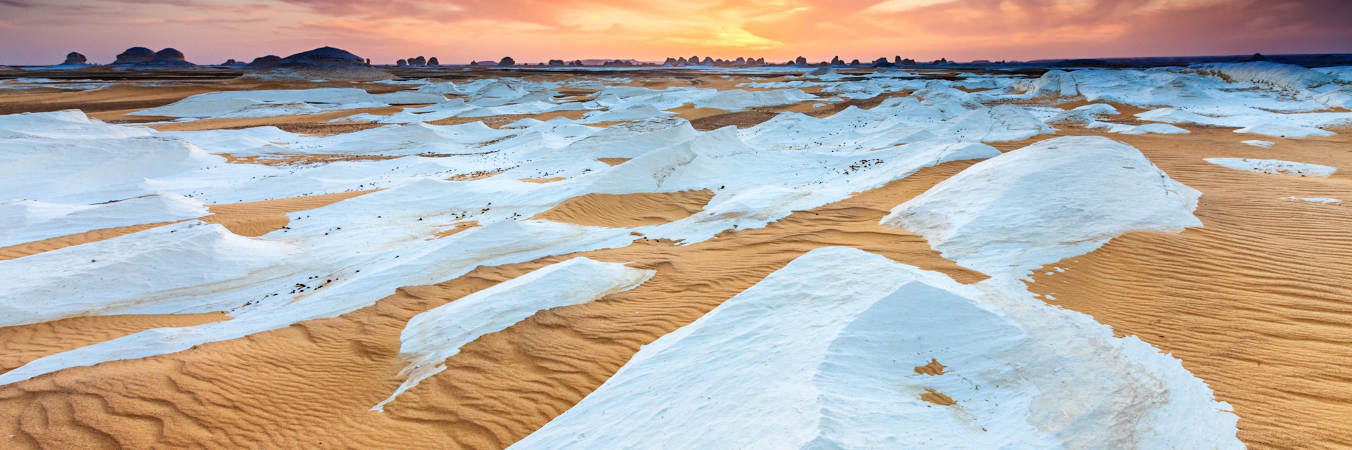 "Sunset over  The White Desert, part of The Western Sahara Desert in Egypt. The White Desert of Egypt is located 45 km (28 mi) north of the town of Farafra. The desert has a white, cream color and has massive chalk rock formations that have been created as a result of occasional sandstorm in the area."