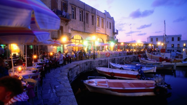 Night-life: Fishing boats moored in the harbour, while people eat out along the waterfront - Rethymno, Rethymno Province, Crete