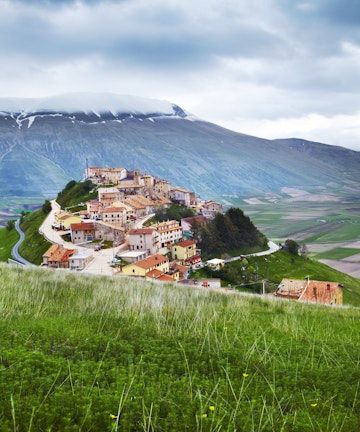 Monti Sibillini towering above hilltop village of Castelluccio.