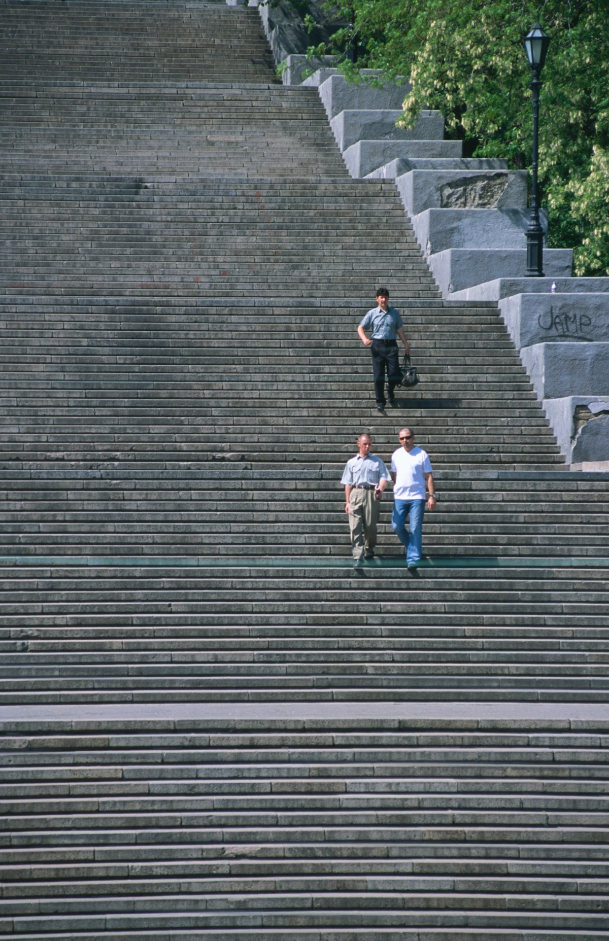 Three men walking down Potemkin Steps.