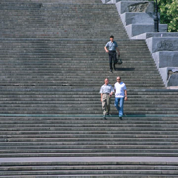 Three men walking down Potemkin Steps.