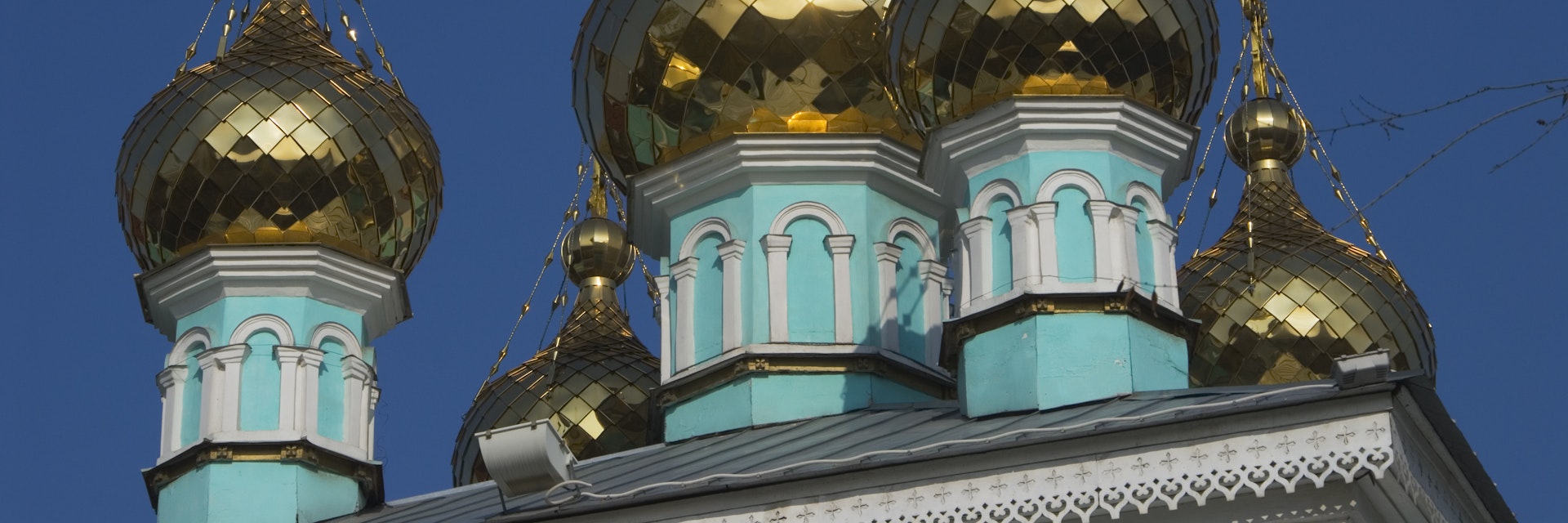Gold onion domes on turquoise St. Nicholas church (Nikolsky Sobor) on Baytursynuly street.