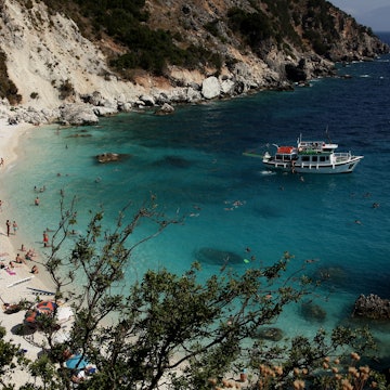 VASSILIKI, GREECE - JULY 21: Visitors who had arrived on a local tourist boat swim in the turquoise waters at Agiofili Beach on July 21, 2010 near Vassiliki, on the island of Lefkada, Greece. Lefkada's west coastline has among Europe's most beautiful beaches. (Photo by Sean Gallup/Getty Images)