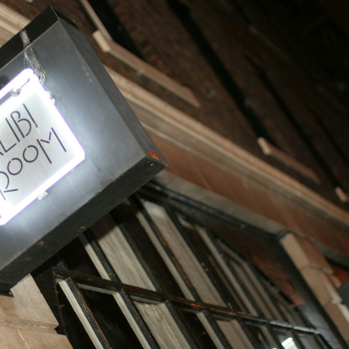 Alibi Room sign, lit at night, Gastown.