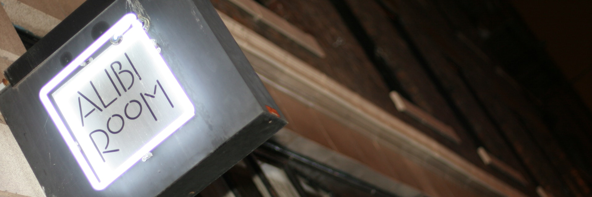 Alibi Room sign, lit at night, Gastown.