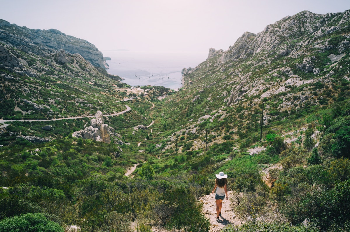 Girl in white hat walking in Calanques National Park. Beautiful film look travel postcard.; Shutterstock ID 639622498