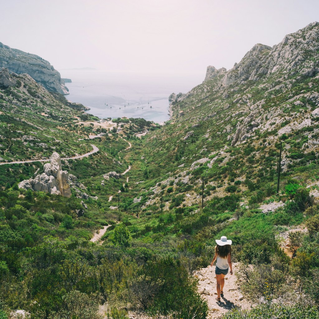 Girl in white hat walking in Calanques National Park. Beautiful film look travel postcard.; Shutterstock ID 639622498