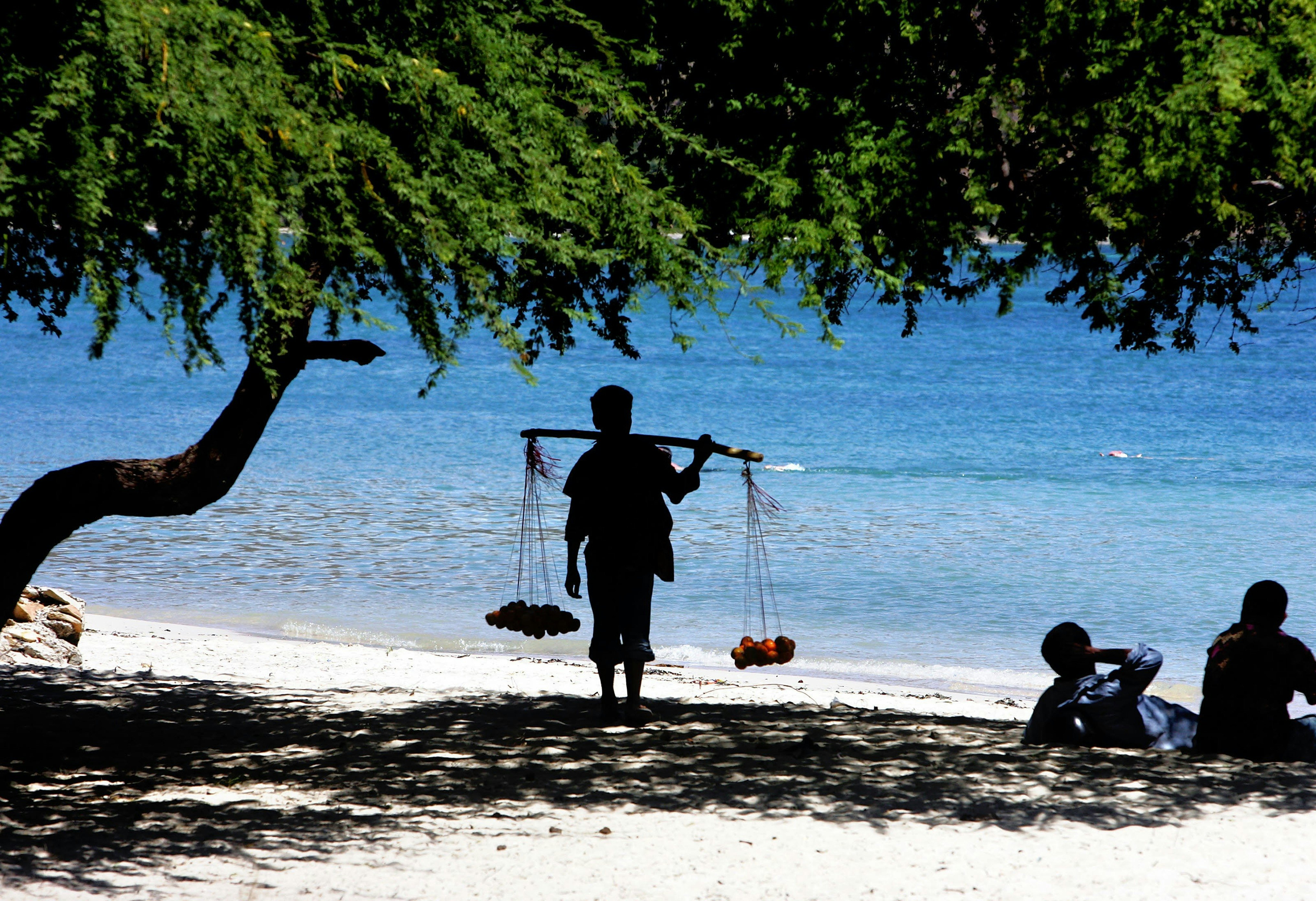 Timor, orange vendor on a beach in Dili