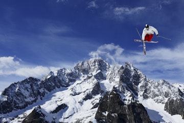Freestyle skier in mid-air in front of Mont Blanc, Courmayeur, Italy, Europe