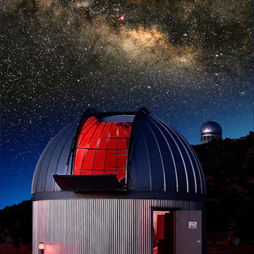 Two observatories at the McDonald Observatory in Ft. Davis, Texas with the summer Milky Way behind them. The Hobby Eberly (spectroscopy) telescope is on the hill in the back.