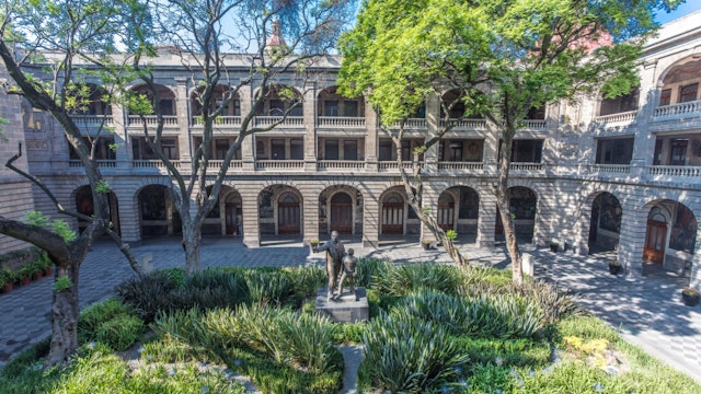 CDMX Mexico City 2018 MAY. Old Custom Ex Antigua Aduana, Antiguo colegio de San Ildefonso, Segreteria Educacion Publica building with internal courts, trees, series of arches paintings by Diego Rivera; Shutterstock ID 1122897197; Your name (First / Last): Sarah Stocking; GL account no.: 65050; Netsuite department name: Online editoiral; Full Product or Project name including edition: Mexico City BIT