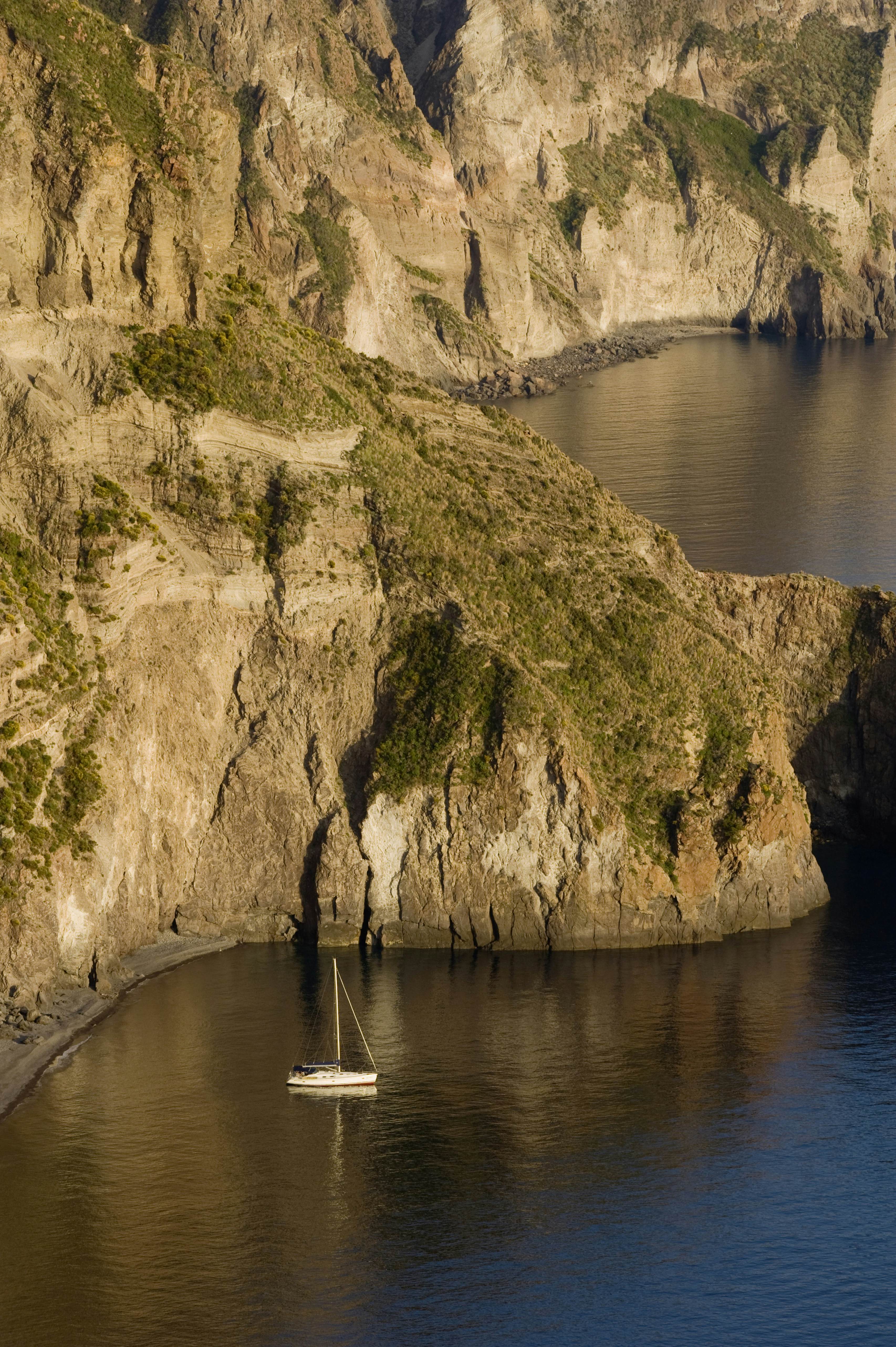 Sailboat in the bay of the Valle Muria, Lipari island, Sicily, Italy, Europe