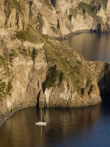 Sailboat in the bay of the Valle Muria, Lipari island, Sicily, Italy, Europe