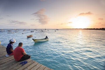 Cape Verde, Sal Island, Santa Maria Beach, tourist looking at sunset over sea