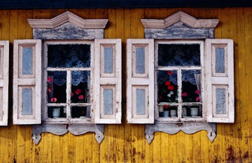 Detail of exterior wall of wooden cottage on Gudine Street in Listvyanka village on Lake Baikal.