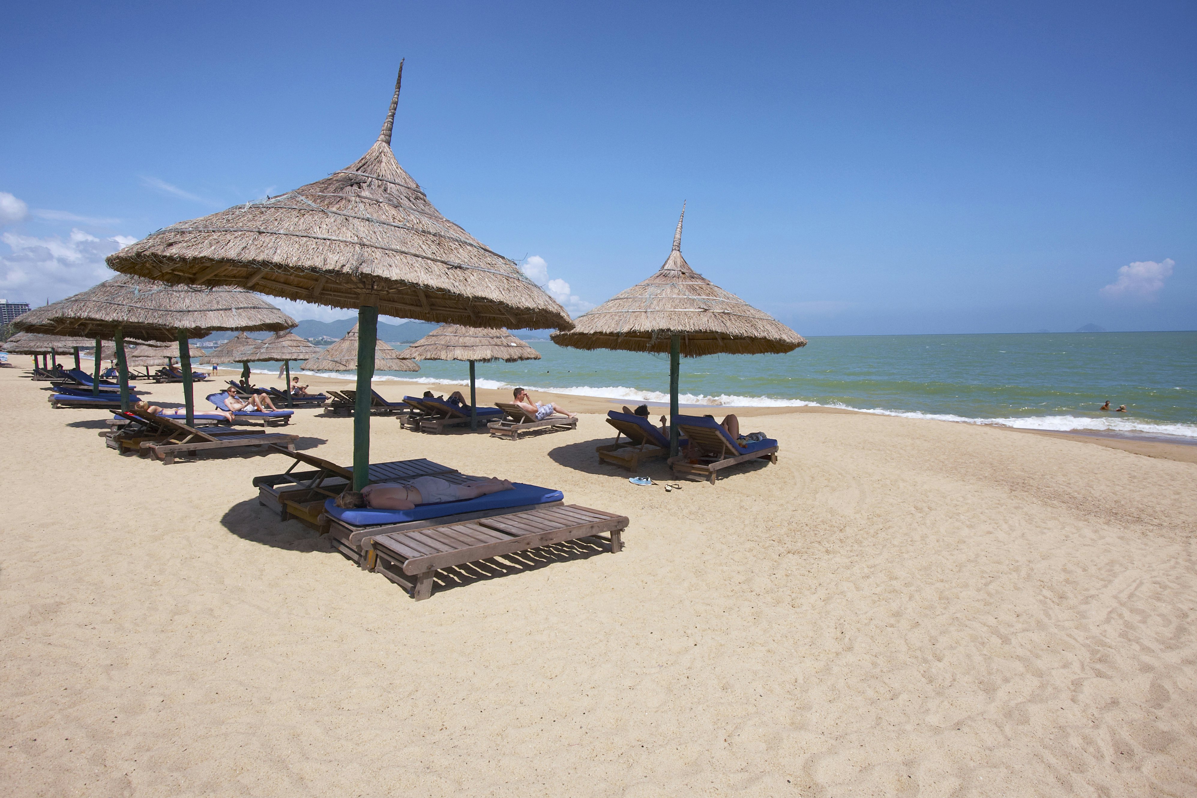 Tourists on sun loungers on Nha Trang's Municipal Beach.