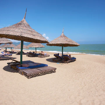 Tourists on sun loungers on Nha Trang's Municipal Beach.