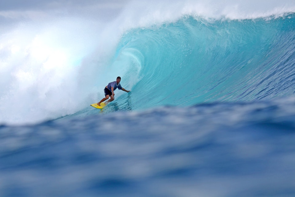 Surfer in barrel of wave.