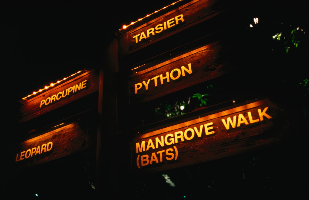 Signs illuminated at night on the Night Safari at the Singapore Zoological Gardens.