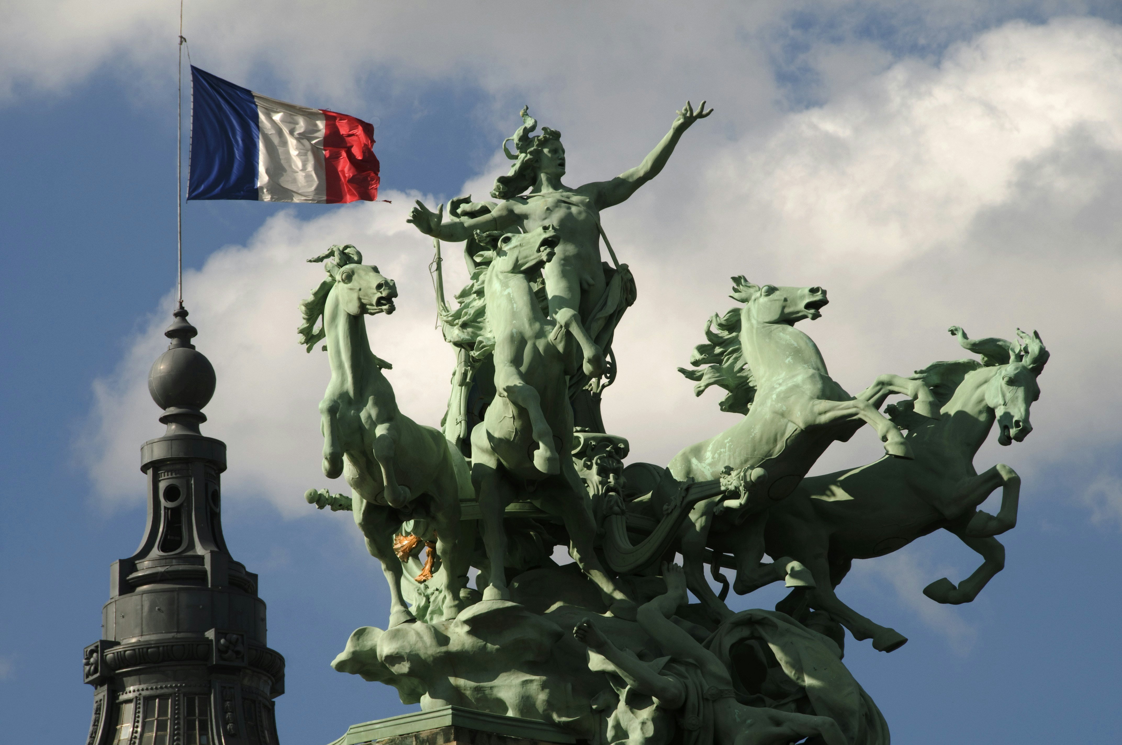 Spire and sculptures on roof of Grand Palais.