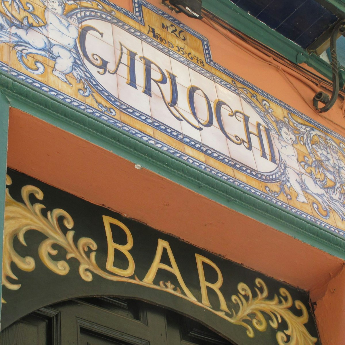 Garlochi bar sign over entrance in tiles.