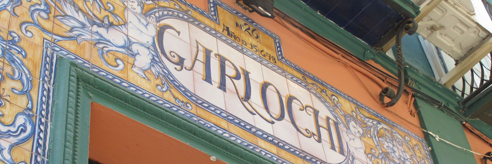 Garlochi bar sign over entrance in tiles.