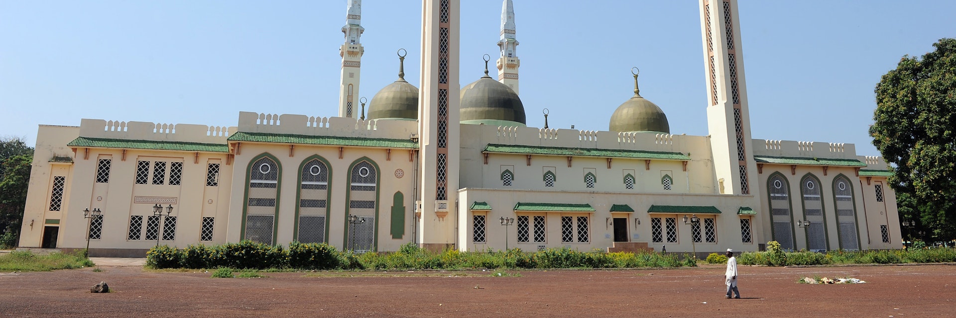 A man walks in front of the Great Mosque on December 2, 2010 in Conakry, as Guinea waited anxiously today for the Supreme Court to confirm presidential election results. Opposition leader Alpha Conde was announced the victor of Guinea's first democratic election since independence on November 15 with 52.5 percent of votes over rival Cellou Dalein Diallo who scored 47.5 percent, sparking accusations of voting fraud. AFP PHOTO / PASCAL GUYOT        (Photo credit should read PASCAL GUYOT/AFP/Getty Images)