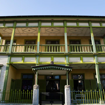 NAGASAKI, NAGASAKI-KEN, JAPAN - 2010/07/20: The former Nagasaki International club built in 1903. Dejima, literally "protruding island", was a small island in the bay of Nagasaki that was a Dutch trading post during Japan's self-imposed isolation of the Edo period from 1641 until 1853. Here Dutch traders were stationed, keeping a small window on the outside world plus trade with the rest of the world..Since the closing of the Dutch East India Company's trading post in 1857, the island has been surrounded by reclaimed land and merged into Nagasaki. The island was designated a national historical site in 1922. Today, Dejima is a work in progress with the long-term plan to fully restore its characteristic fan-shaped form and all the embankment walls.. (Photo by John S Lander/LightRocket via Getty Images)