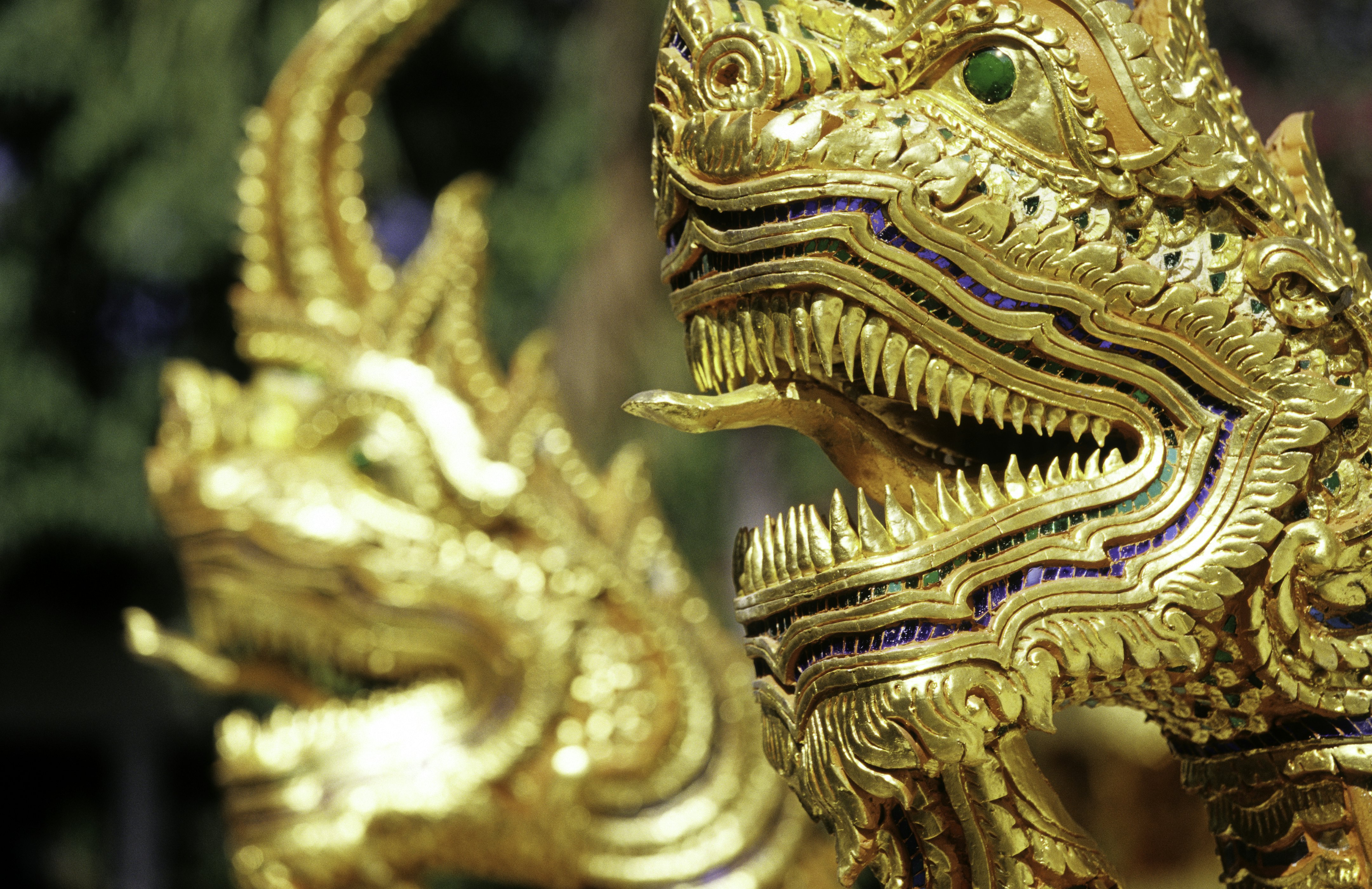 Wat Mahawan, golden naga figures guarding temple.