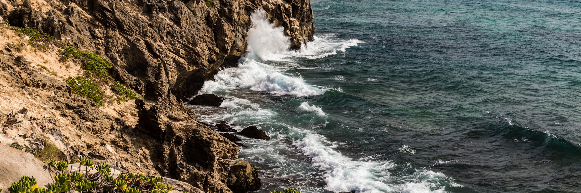 Cliff and crashing waves on Maha'ulepu Heritage Trail on Kauai.