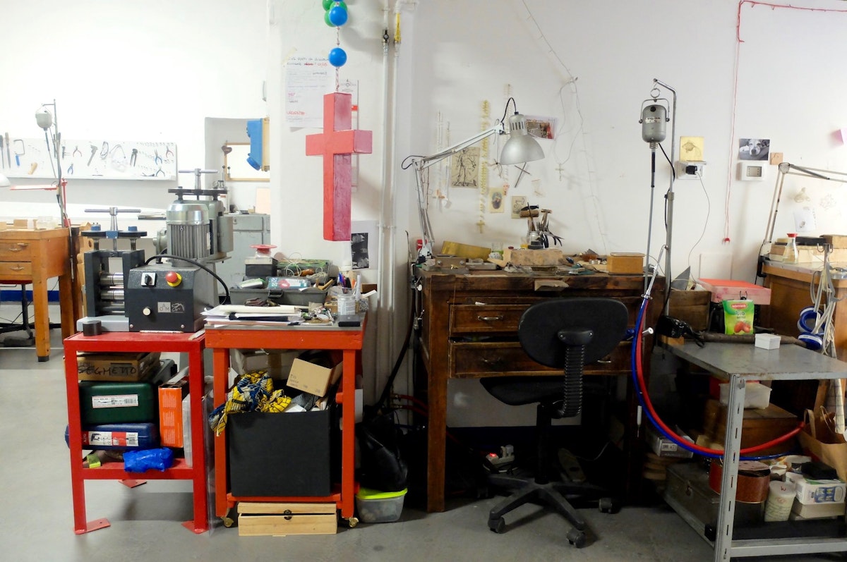 A crowded desk inside the studio of Officina Nora