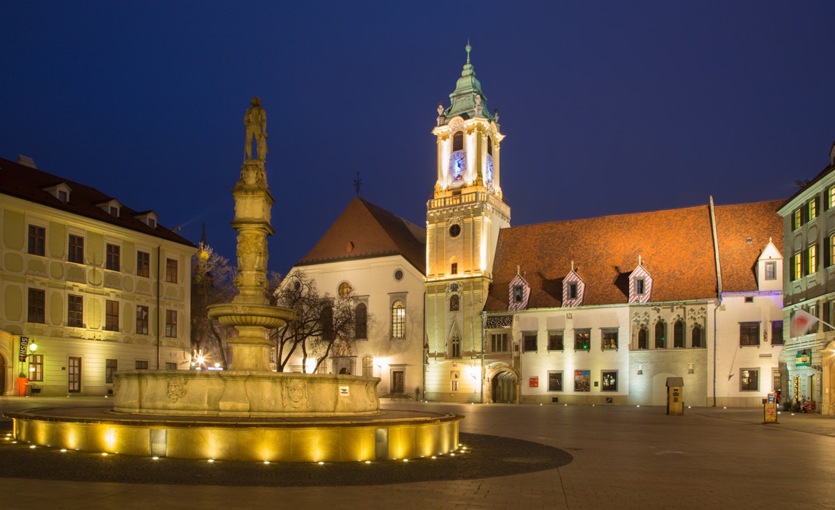 BRATISLAVA, SLOVAKIA - JANUARY 23, 2014: Main square in evening dusk with the town hall and Jesuits church.; Shutterstock ID 173572751; Your name (First / Last): Gemma Graham; GL account no.: 65050; Netsuite department name: Online Editiorial; Full Product or Project name including edition: POI image