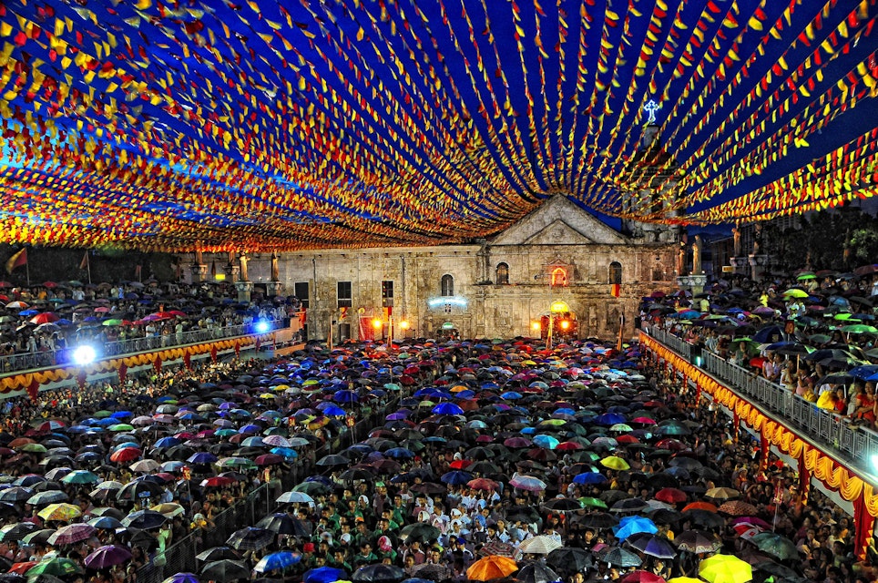 Pilgrims endure the rain to hear mass on the 6th day Novena for the coming Fiesta of Sr. Sto. Niño held at The Basilica Del Sto. Nino De Cebu, Cebu City, Philippines..Cebuanos and devotees alike recite nine consecutive days of prayers, also known as the Novena, in celebration and thanksgiving to Señor Santo Niño..Masses are held every other hour from early morning until evening during the Novena in order to cope with the enormous crowds that flood the Basilica.