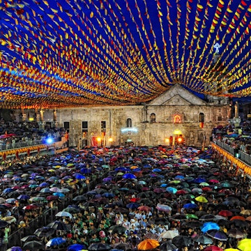 Pilgrims endure the rain to hear mass on the 6th day Novena for the coming Fiesta of Sr. Sto. Niño held at The Basilica Del Sto. Nino De Cebu, Cebu City, Philippines..Cebuanos and devotees alike recite nine consecutive days of prayers, also known as the Novena, in celebration and thanksgiving to Señor Santo Niño..Masses are held every other hour from early morning until evening during the Novena in order to cope with the enormous crowds that flood the Basilica.