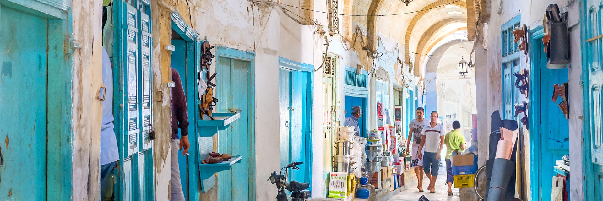 Kairouan, Tunisia - August 30, 2015: Almost all the stalls in Souq El-Blaghija market are closed after midday that's why it could be used as parking for cycles and scooters.