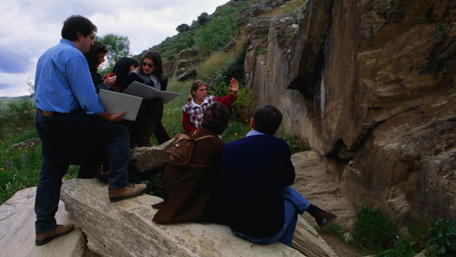 A group visit one of the Paleolithic rock art in the Archeological Park in the Coa Valley, or Parque Arqueologico Vale do Coa, near Vila Nova de Foz Coa. The largest site of such art work found to date the site has been heritage listed.