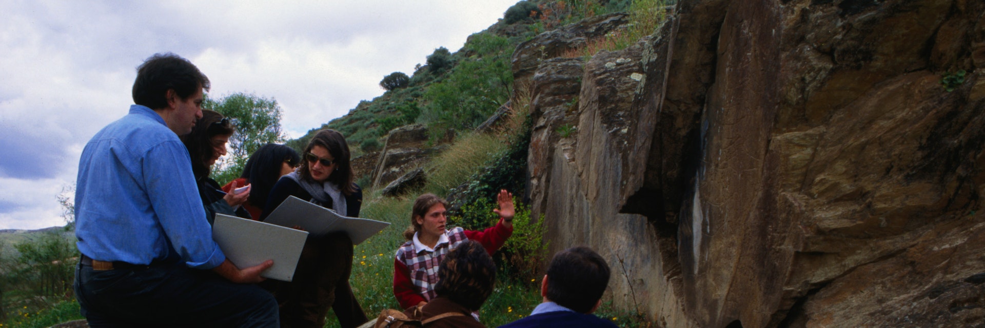 A group visit one of the Paleolithic rock art in the Archeological Park in the Coa Valley, or Parque Arqueologico Vale do Coa, near Vila Nova de Foz Coa. The largest site of such art work found to date the site has been heritage listed.