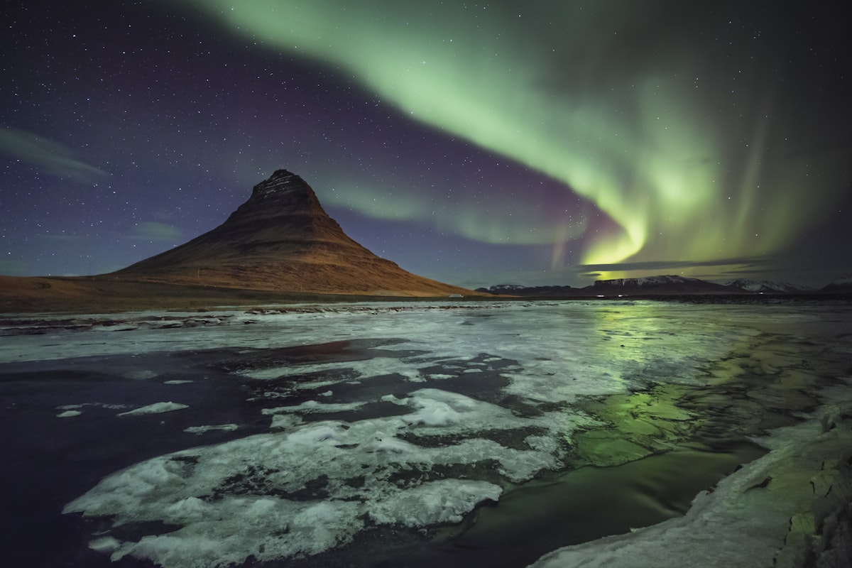 Kirkjufell mountain, Western Iceland, as the aurora really starts to pump out, illuminating the frozen landscape. ....From a superb trip with David Clapp and Antony Spencer