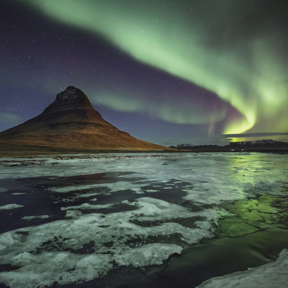 Kirkjufell mountain, Western Iceland, as the aurora really starts to pump out, illuminating the frozen landscape. ....From a superb trip with David Clapp and Antony Spencer