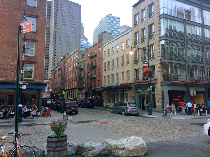 An intersection with businesses in the South Street Seaport