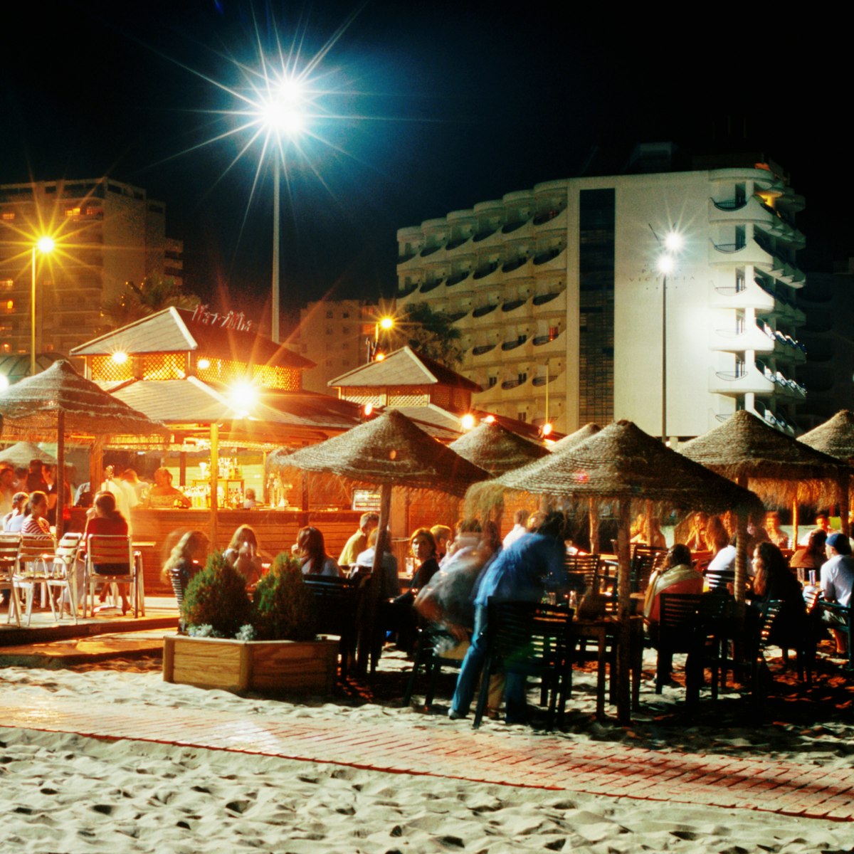 Beach bars and customers on Playa de la Victoria.