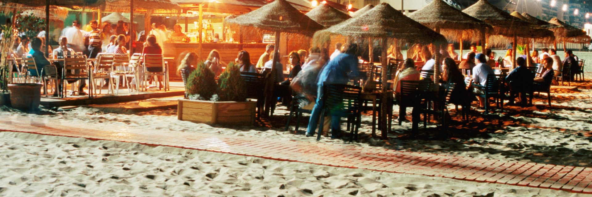 Beach bars and customers on Playa de la Victoria.