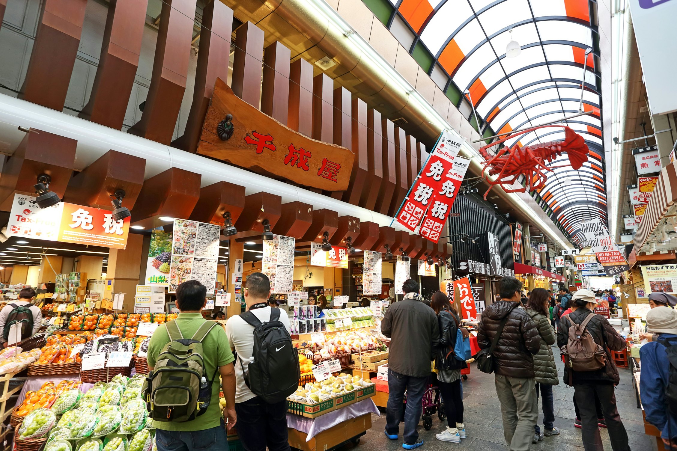 OSAKA, JAPAN - NOV 6: Tourists shopping and visit  in Kuromon Ichiba market on November 6, 2015 in Osaka, Japan. it is market places popular of Osaka; Shutterstock ID 413962024; Your name (First / Last): Laura Crawford; GL account no.: 65050; Netsuite department name: Online Editorial; Full Product or Project name including edition: Osaka city app POI images