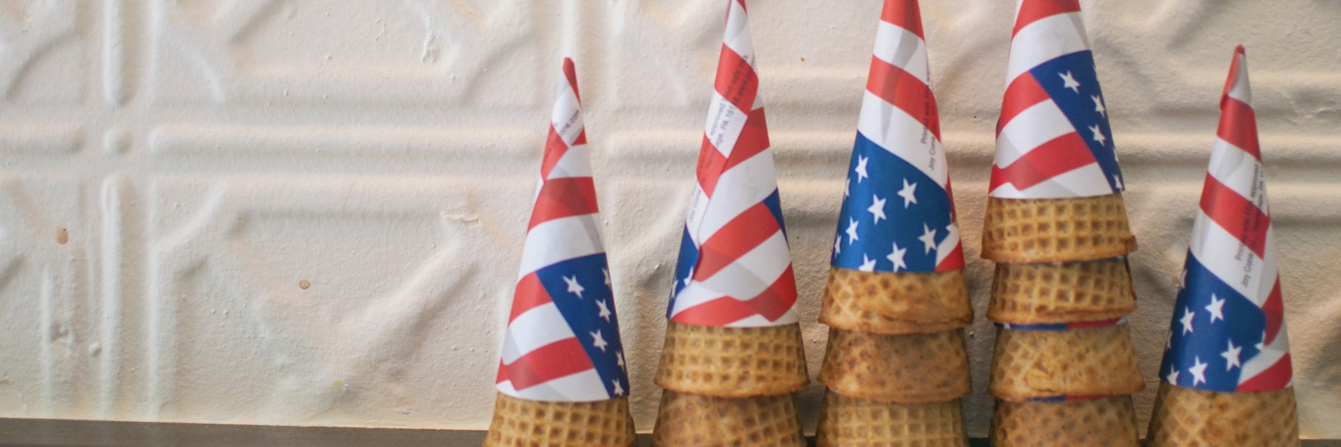 Brooklyn Ice Cream Factory dresses its staff and cone holders in the stars and stripes of the American flag.