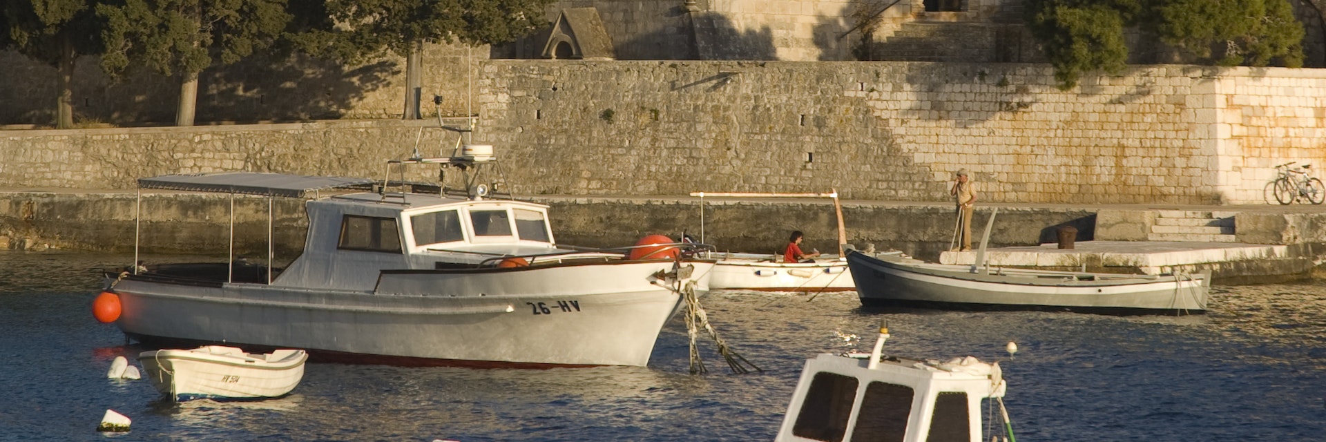 Fishing boats and Franciscan monastery.
