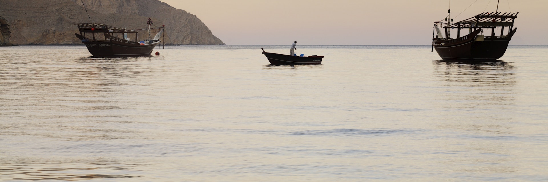 Fishing boats in water at dawn near Kumzar Village.