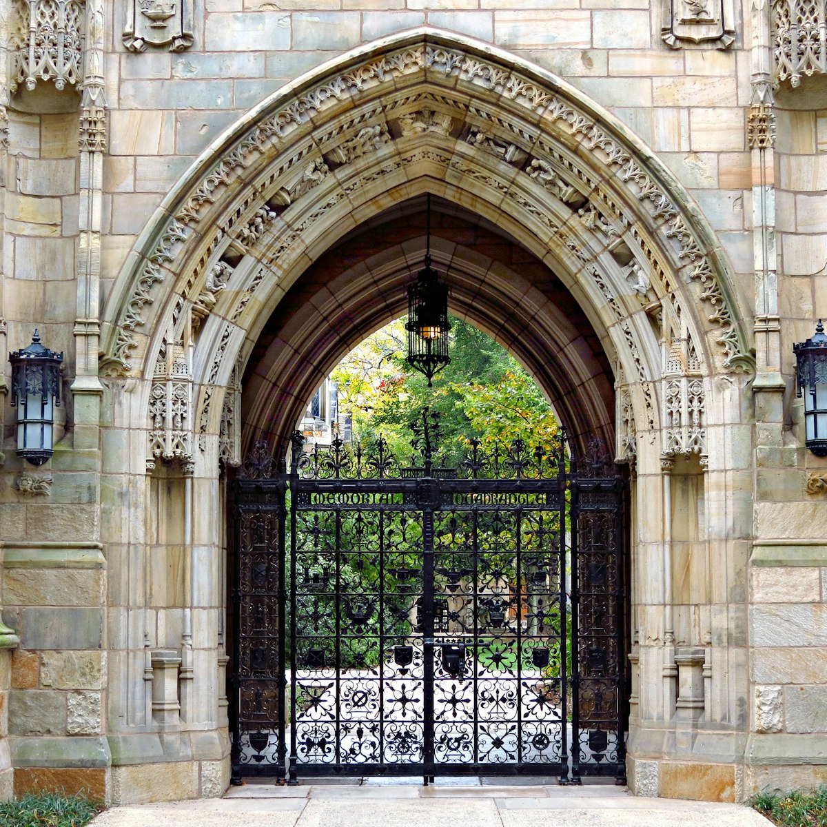 This decorative iron gate is the entrance to the Memorial Quadrangle on the campus of Yale University. The gate beneath Harkness Tower, crafted by Samuel Yellin, is the most ornate of his many works at Yale.